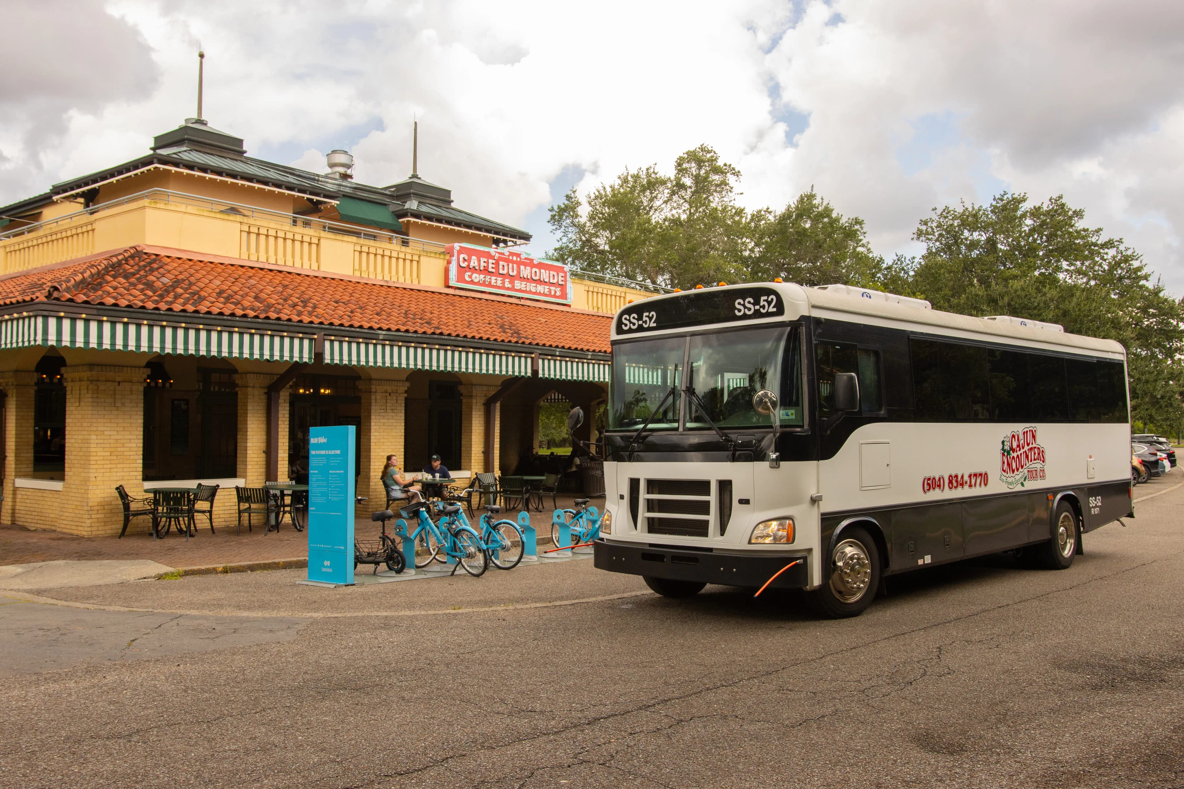 Cajun Encounters guided city bus tour outside Café Du Monde in New Orleans