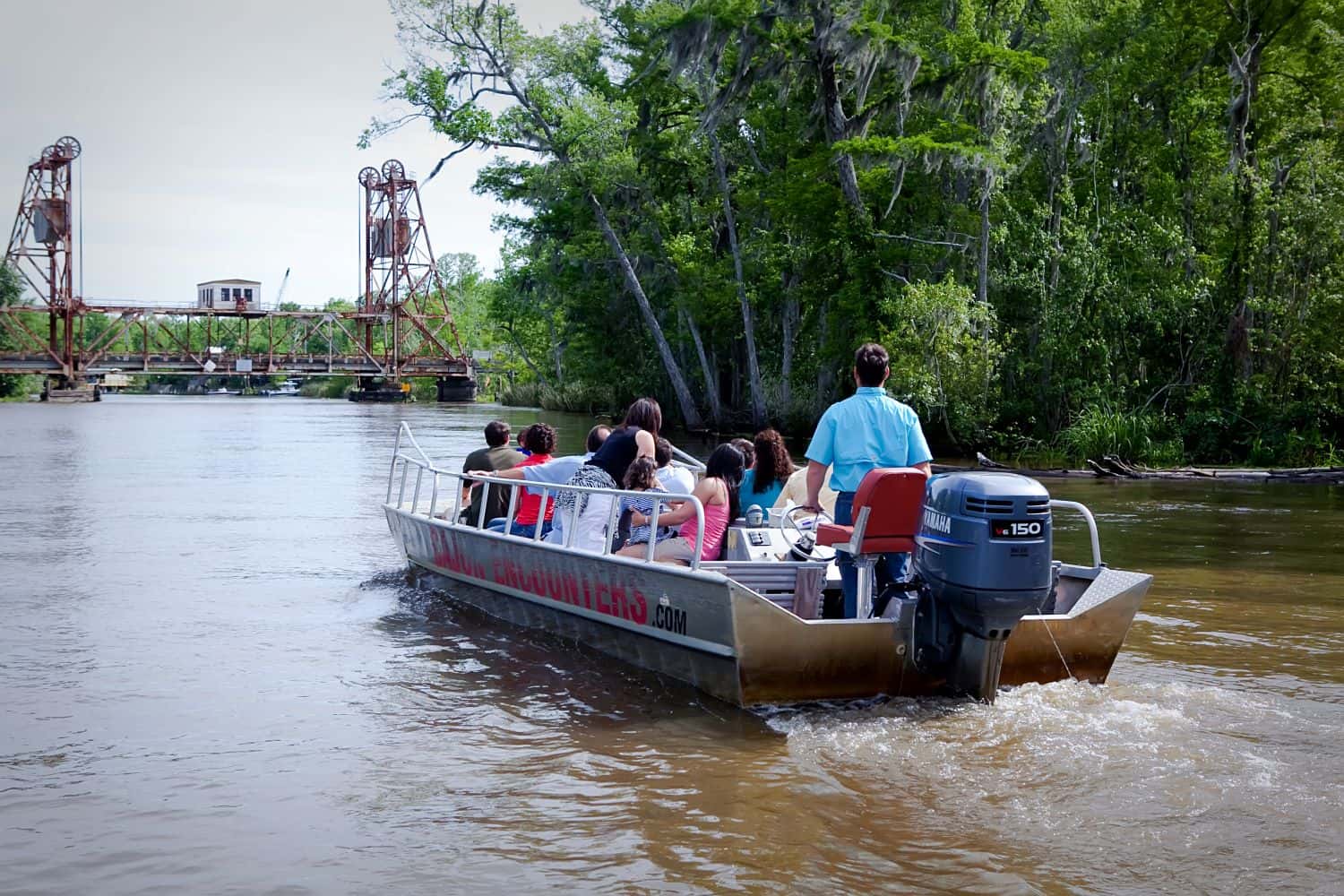 A Cajun Encounters tour boat approaching the Pearl River Bridge