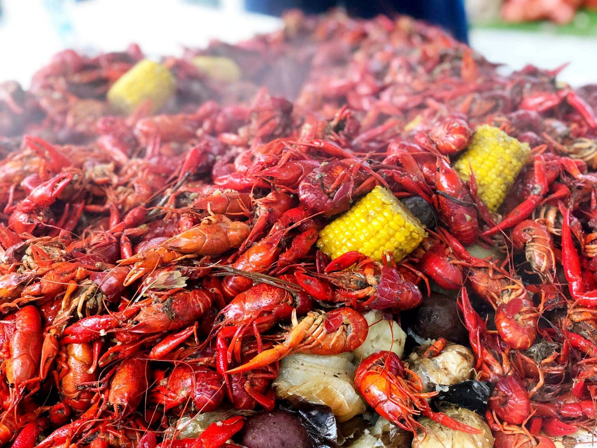 Crawfish, corn, potatoes, and other boil ingredients on a table during crawfish season 2024