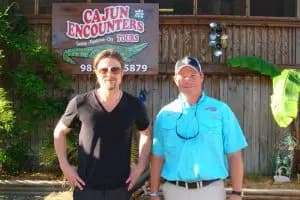 Brad Pitt and Jeff Rogers standing in front of the Cajun Encounters Pavilion before a swamp tour