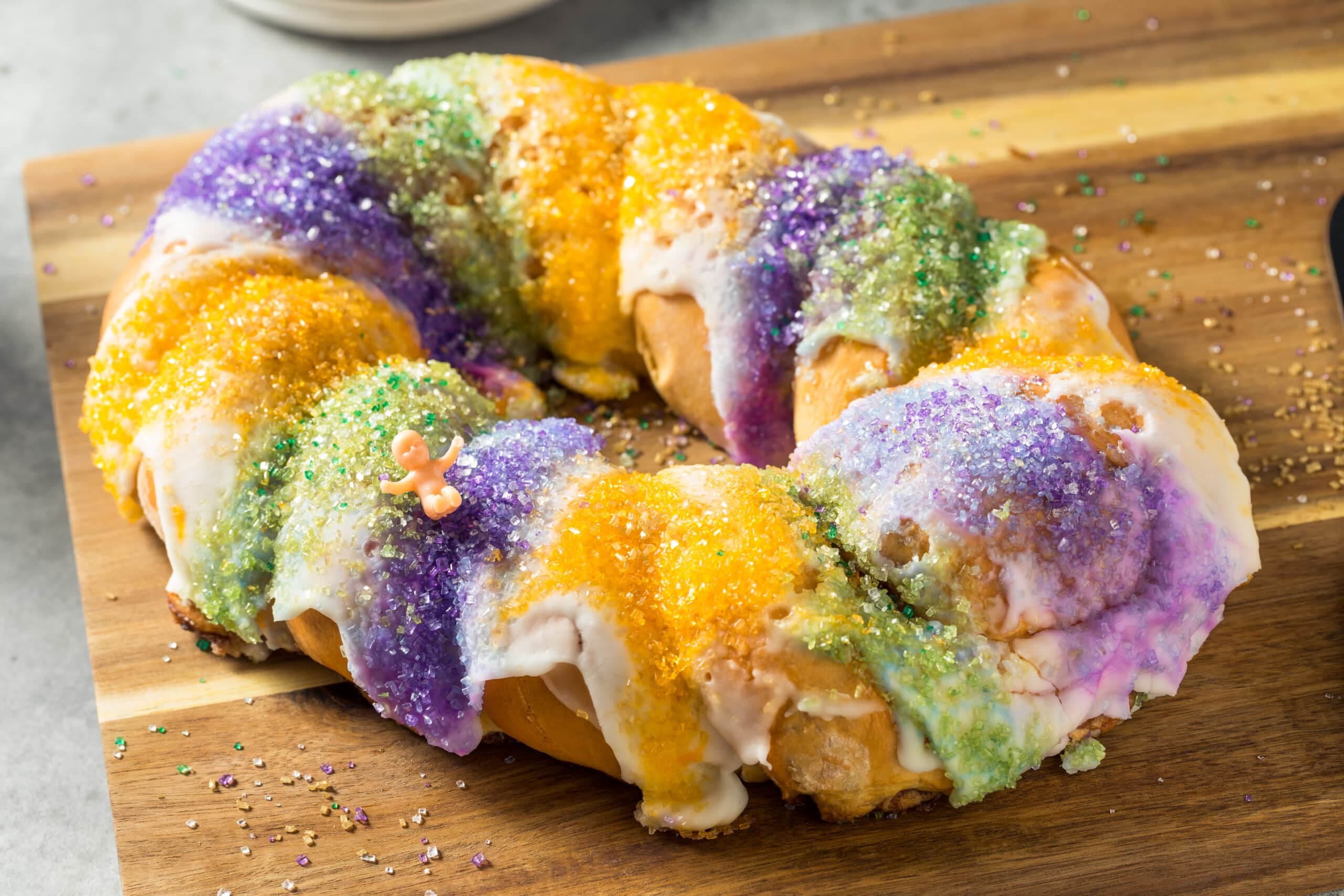 Traditional-style new orleans king cake with purple, green, and gold mardi gras colored sprinkles