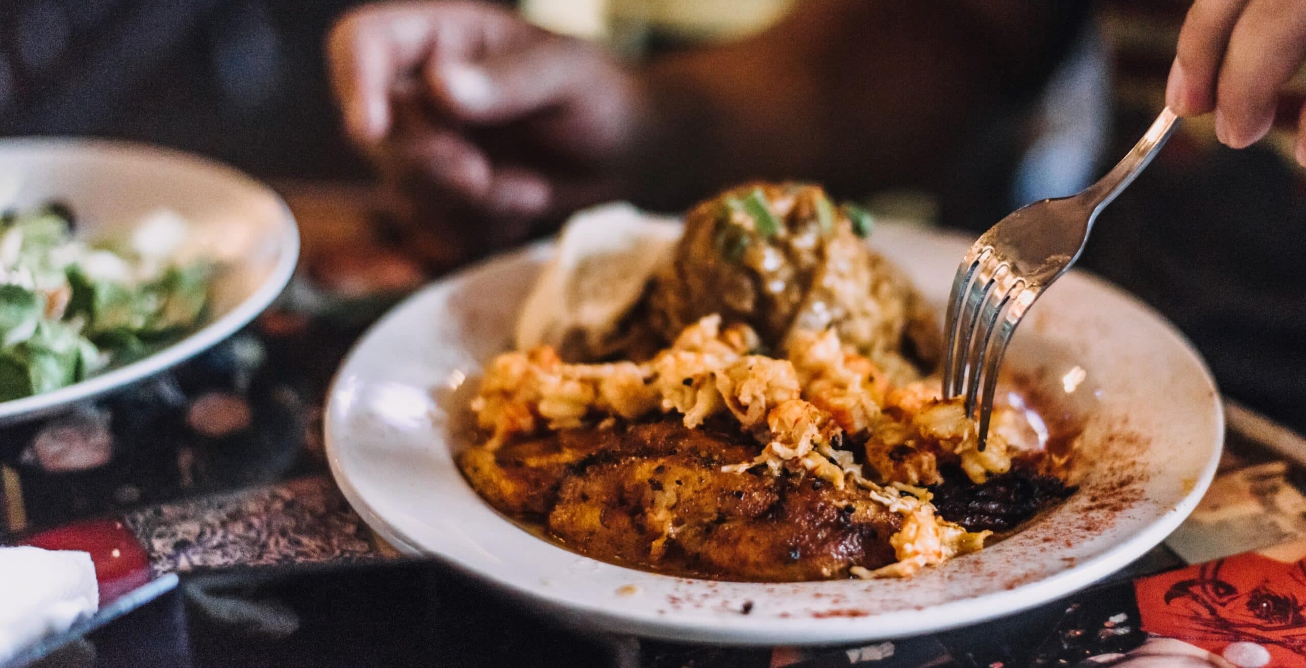 A person enjoying a traditional New Orleans cuisine dish